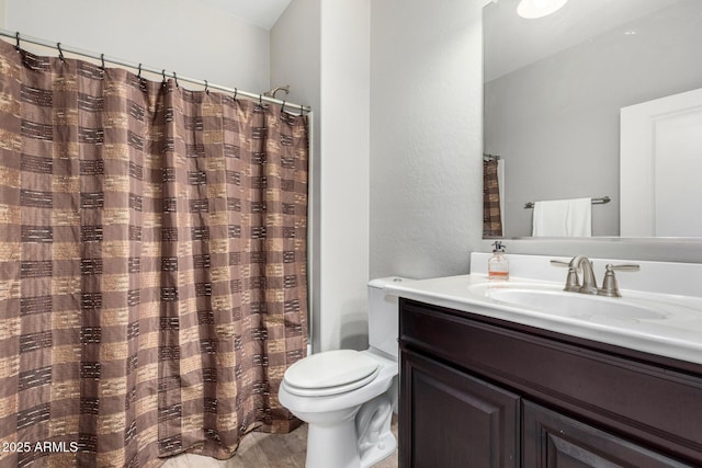 full bathroom with toilet, wood finished floors, and vanity