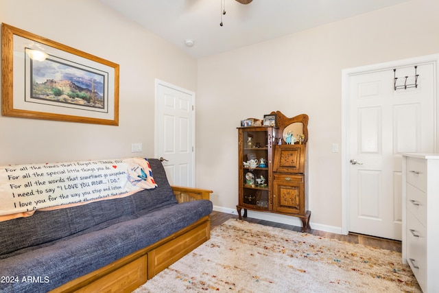 sitting room with hardwood / wood-style floors and ceiling fan