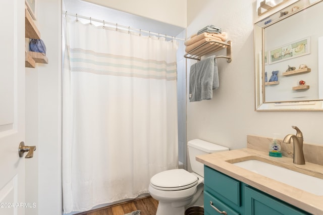 bathroom with vanity, hardwood / wood-style flooring, and toilet