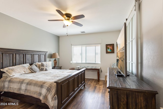 bedroom with ceiling fan and dark hardwood / wood-style floors