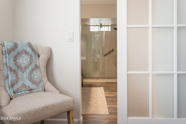 bathroom featuring hardwood / wood-style floors and a shower with door