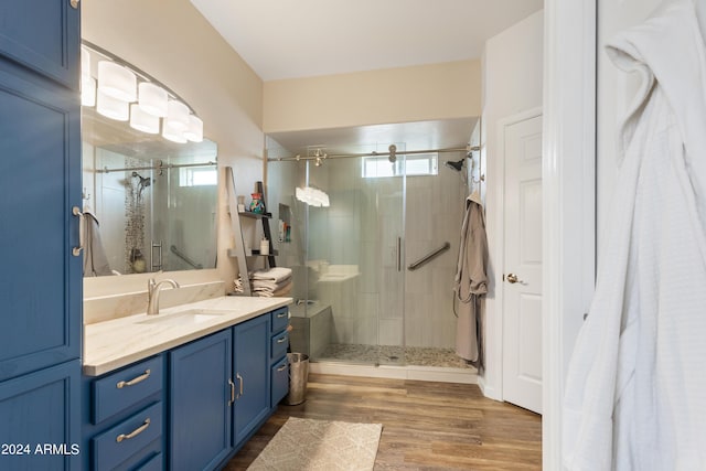 bathroom with plenty of natural light, wood-type flooring, and walk in shower