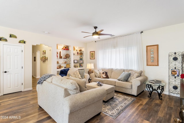 living room featuring ceiling fan and dark hardwood / wood-style floors