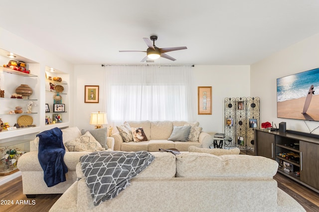 living room with ceiling fan, built in features, and dark wood-type flooring