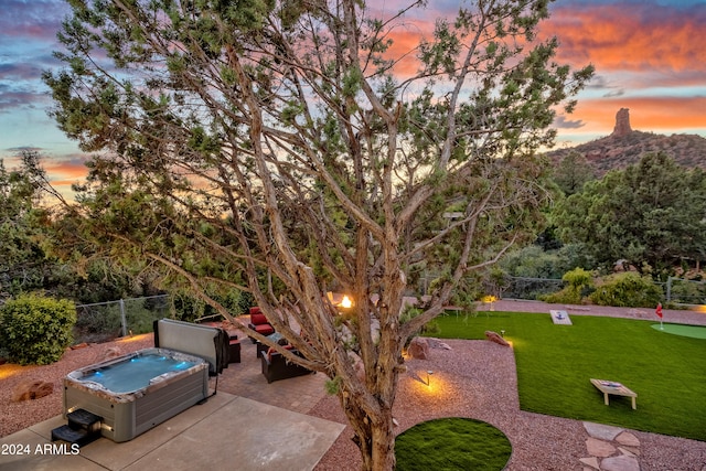 surrounding community featuring a lawn, a patio, a mountain view, and a jacuzzi