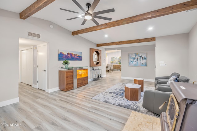 living room with ceiling fan, vaulted ceiling with beams, and light hardwood / wood-style flooring