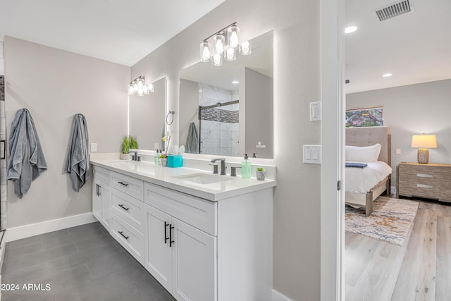 bathroom with wood-type flooring, vanity, and an enclosed shower