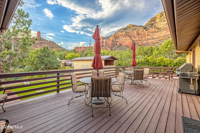 deck with a mountain view and grilling area