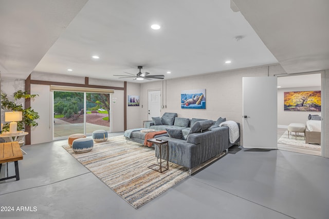 living room with concrete flooring and ceiling fan