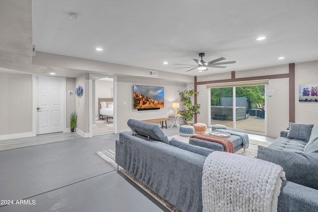 living room featuring concrete floors and ceiling fan