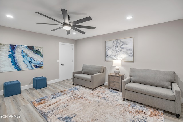 living area featuring ceiling fan and hardwood / wood-style floors