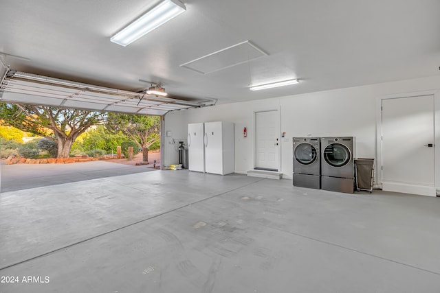 garage featuring a garage door opener and separate washer and dryer