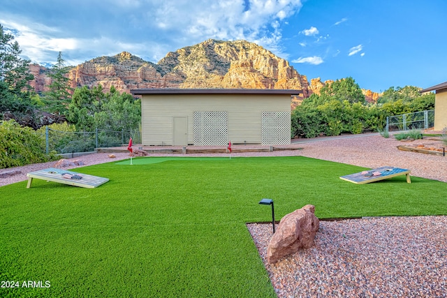 back of property featuring a mountain view and a yard