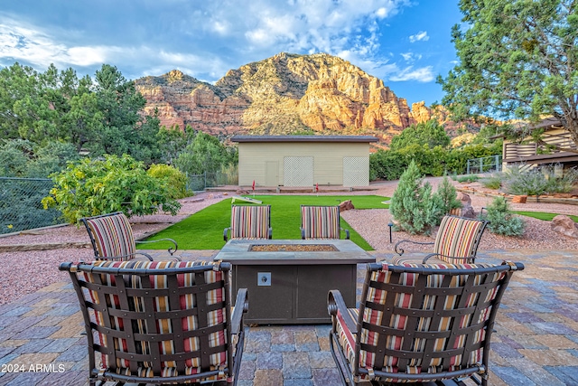 view of patio / terrace with an outdoor fire pit and a mountain view