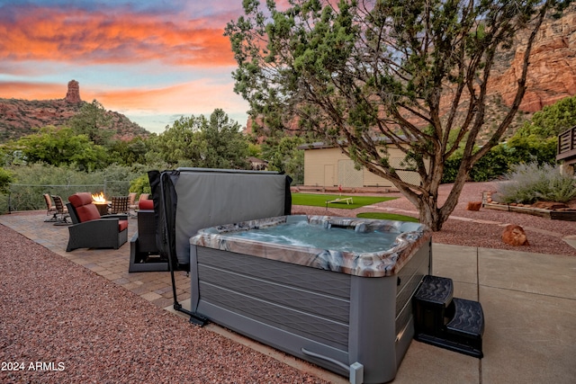 patio terrace at dusk with a hot tub