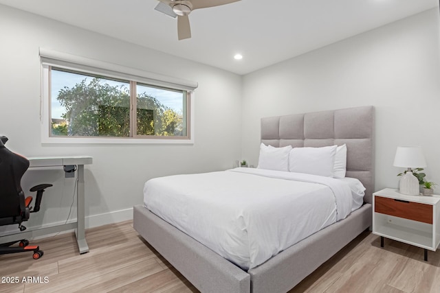 bedroom with ceiling fan and light hardwood / wood-style flooring