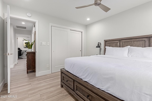 bedroom featuring a closet, ceiling fan, and light hardwood / wood-style flooring