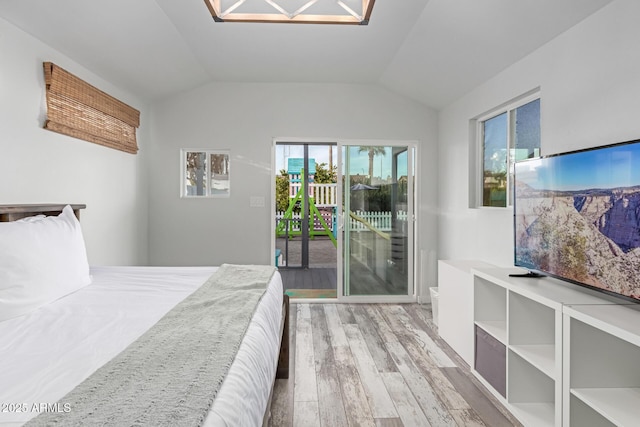 bedroom featuring vaulted ceiling, access to outside, and light hardwood / wood-style floors