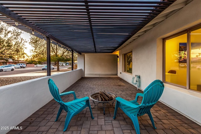 patio terrace at dusk featuring a pergola