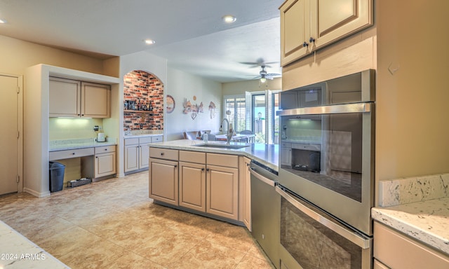 kitchen featuring light tile floors, stainless steel dishwasher, ceiling fan, and sink