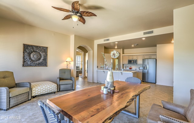 dining room with ceiling fan and light tile floors