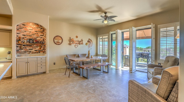 dining room with sink, ceiling fan, and light tile flooring