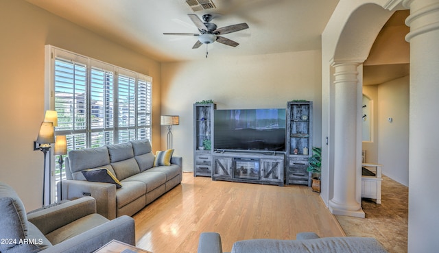 living room with ceiling fan, light wood-type flooring, and decorative columns