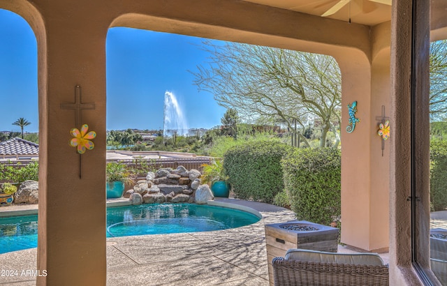 view of pool with a hot tub and a patio