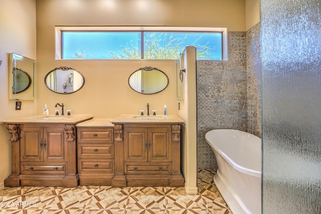 bathroom with tile flooring, a healthy amount of sunlight, and dual bowl vanity