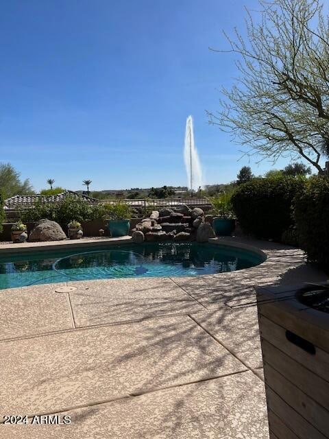 view of swimming pool featuring a patio area