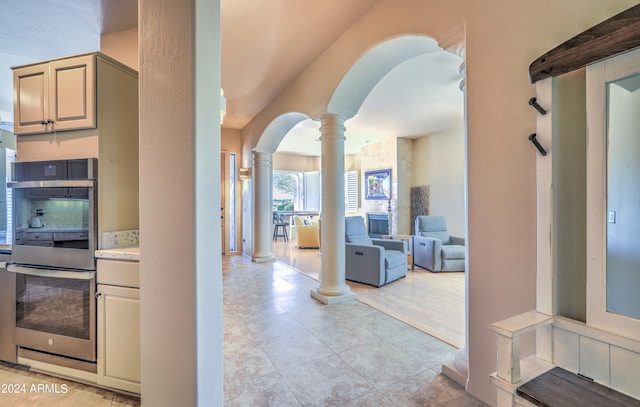 interior space with light tile floors and decorative columns