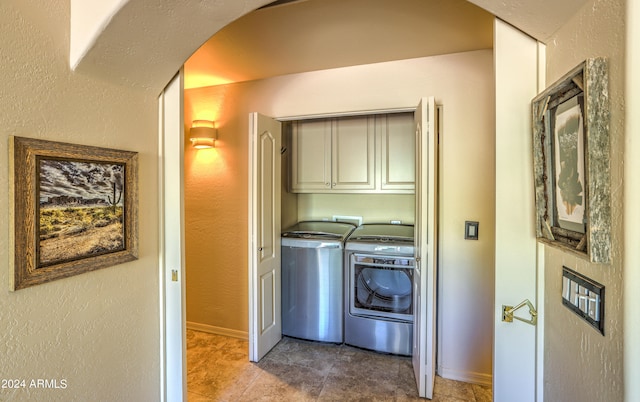 laundry area featuring tile flooring, independent washer and dryer, cabinets, and hookup for a washing machine