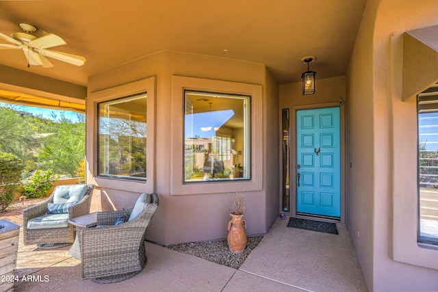 entrance to property featuring a patio and ceiling fan