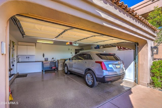 garage featuring a carport and a garage door opener