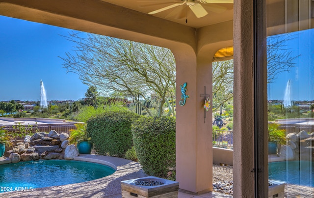 exterior space with a hot tub and ceiling fan