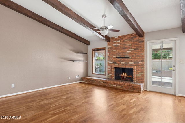2053 W Natal Cir, Mesa, AZ 85202 - unfurnished living room featuring wood finished floors, a ceiling fan, beamed ceiling, and a fireplace