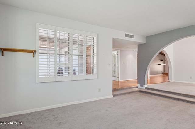 2053 W Natal Cir, Mesa, AZ 85202 - carpeted empty room with arched walkways and healthy amount of natural light