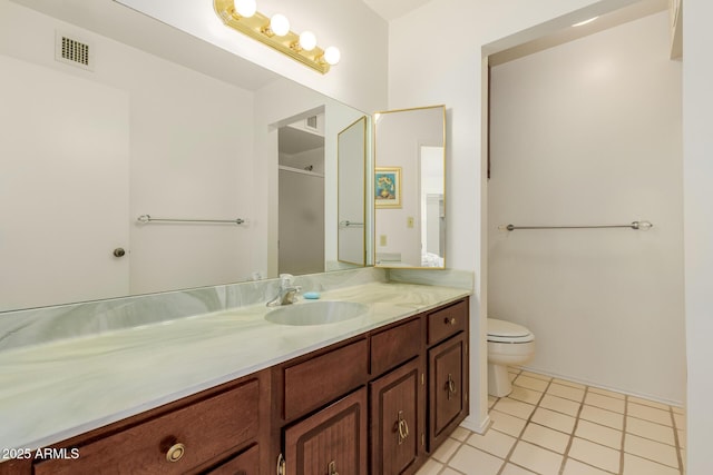 full bathroom with a shower with door, visible vents, toilet, vanity, and tile patterned floors