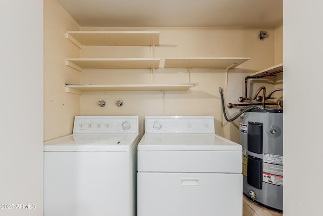 washroom with electric water heater and independent washer and dryer