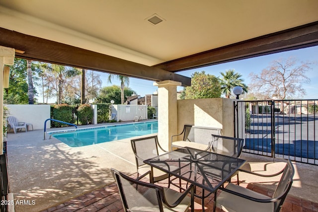 view of swimming pool with fence, a fenced in pool, and a patio