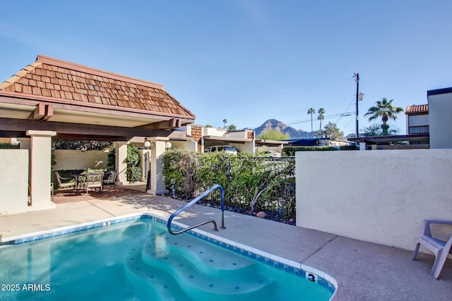 view of pool featuring fence and a patio