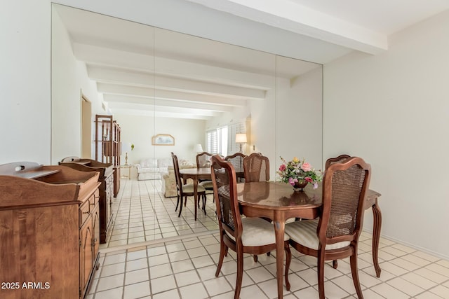 dining room with beamed ceiling and light tile patterned flooring