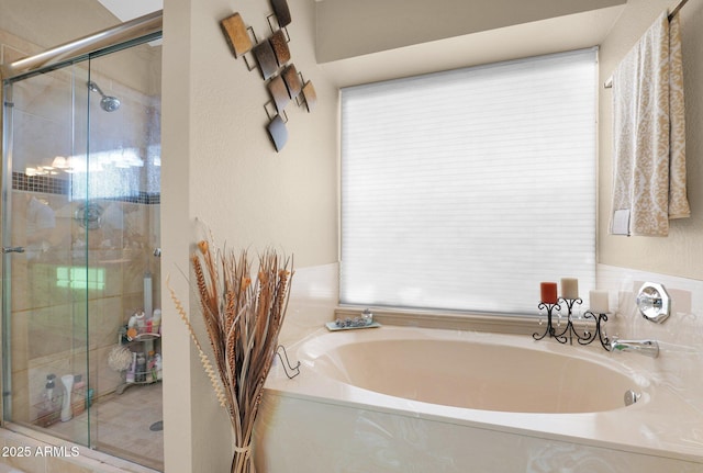 bathroom featuring shower with separate bathtub