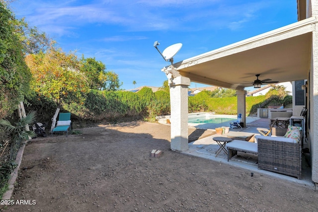 view of yard featuring a fenced in pool, a patio, and ceiling fan