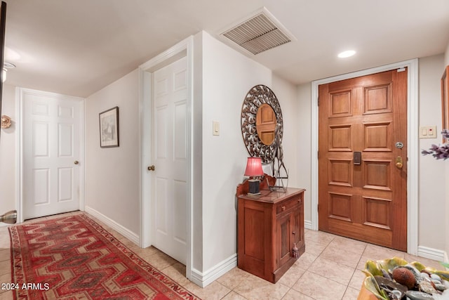 entryway featuring baseboards, visible vents, and light tile patterned floors