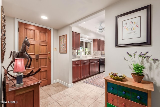 interior space featuring tile patterned flooring, a ceiling fan, vanity, baseboards, and tasteful backsplash