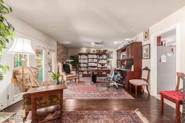 sitting room with ceiling fan and dark hardwood / wood-style flooring