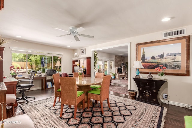 dining space featuring a ceiling fan, wood finished floors, visible vents, and a healthy amount of sunlight
