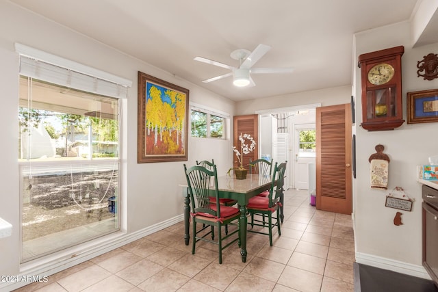dining room with light tile patterned floors, baseboards, and ceiling fan