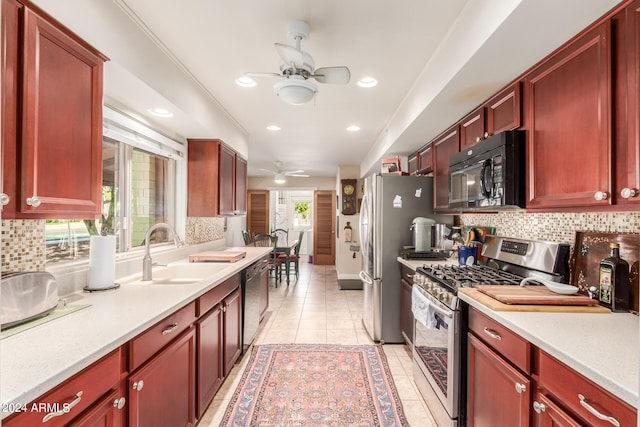 kitchen with ceiling fan, stainless steel appliances, sink, light tile patterned floors, and backsplash